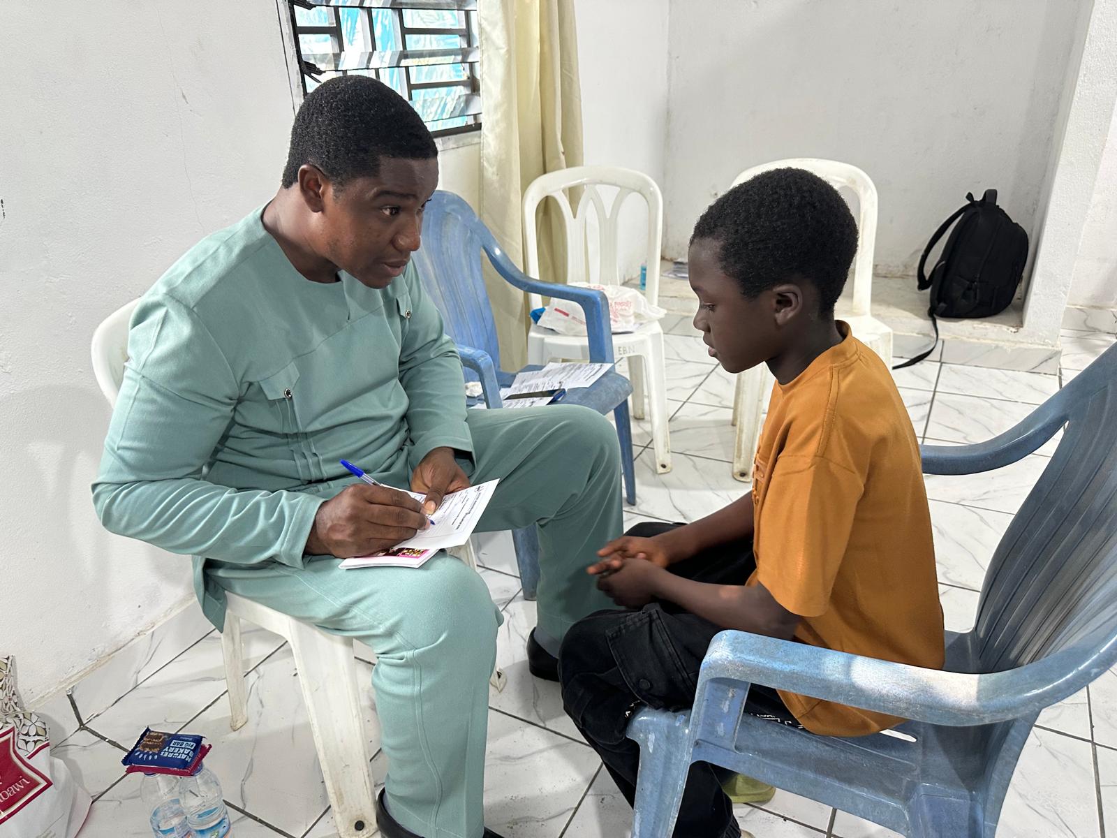A team member counseling a young man