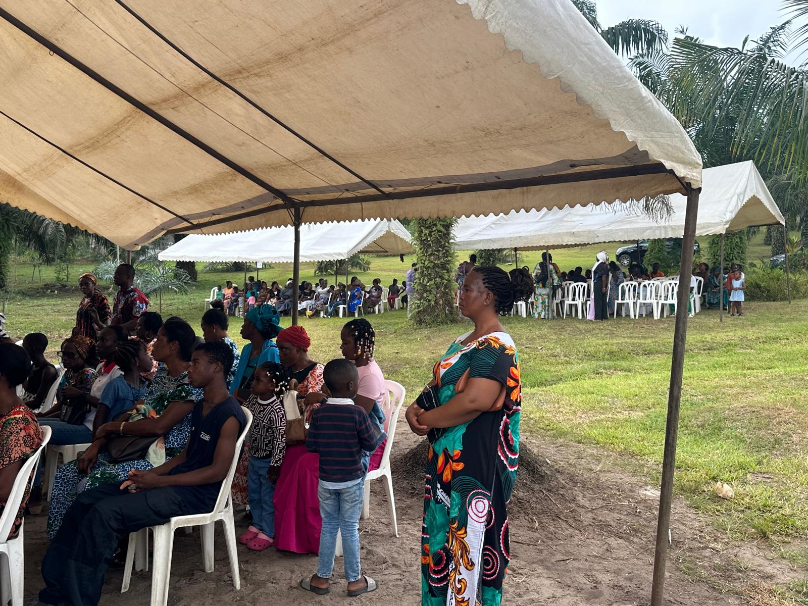 People gathered under the outreach tents