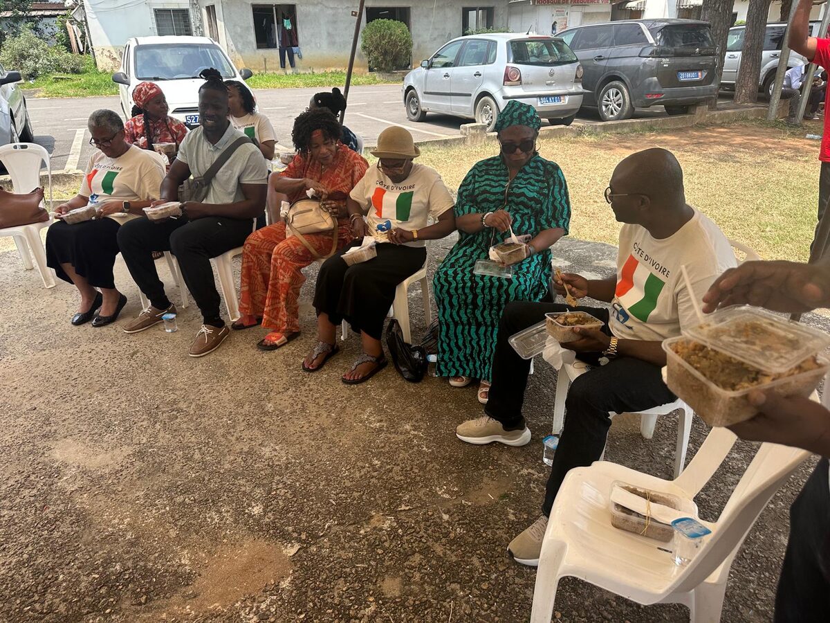Team members sharing a meal under the tents